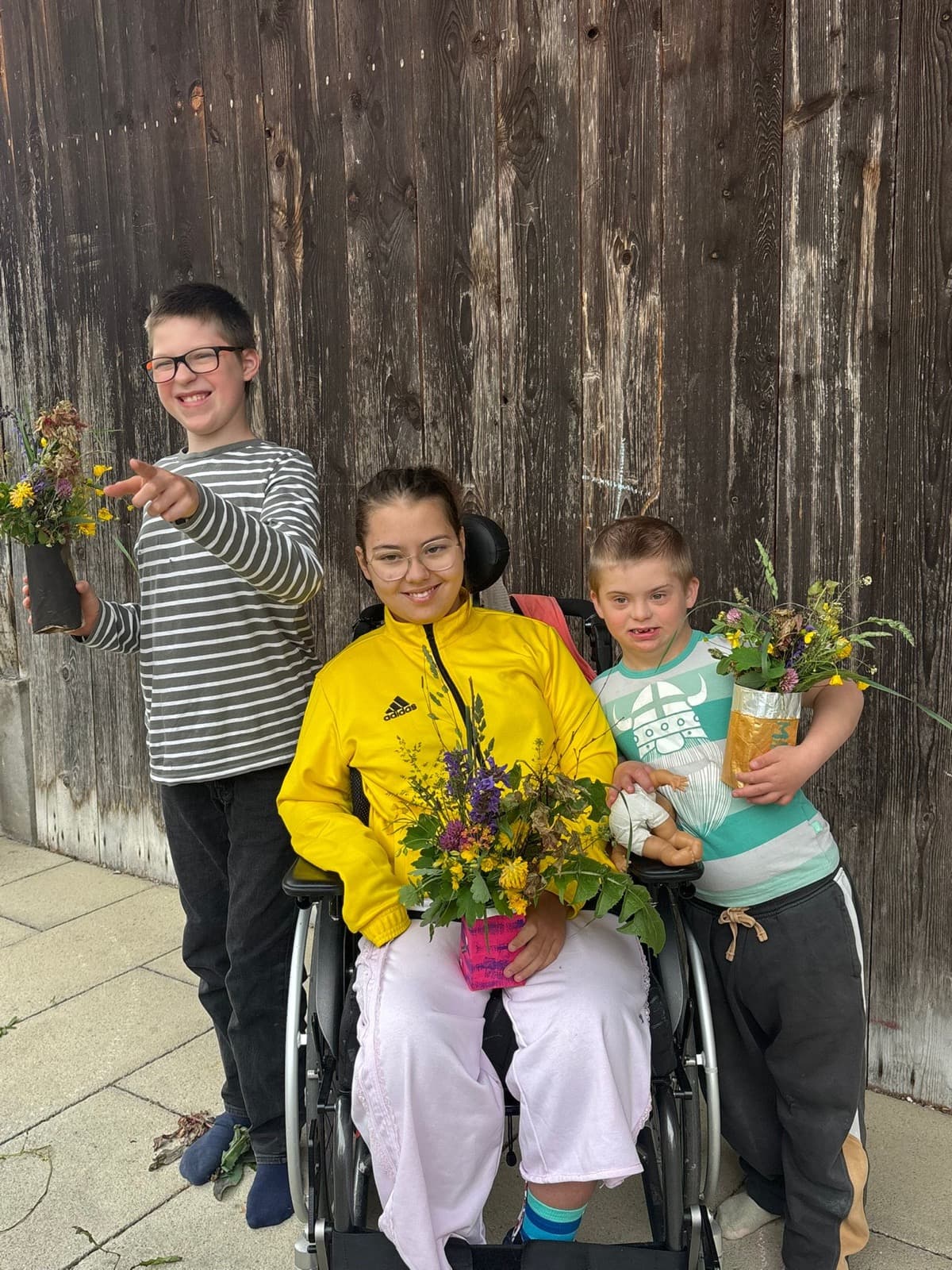 Three children with their homemade flower bouquets